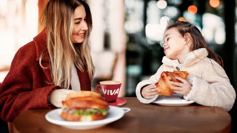 Woman and Child eat and drink in a VIVA Station